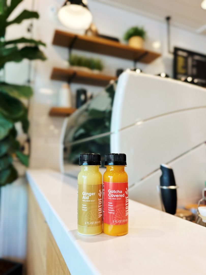 Two of Virtue's Cold Pressed Juice Shots on the counter.